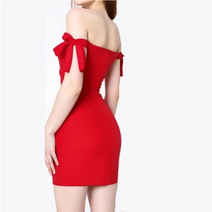 Detail of red off-shoulder cocktail dress featuring a large bow on the shoulder