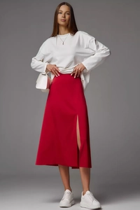 Detail view of red satin midi skirt with elegant side slit and high waist tailoring