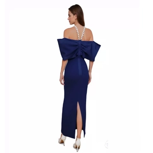 Detail of elegant navy blue evening dress featuring a large back bow and crystal straps