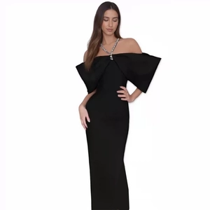 Detail of off-shoulder neckline with elegant oversized bow on black bandage party dress
