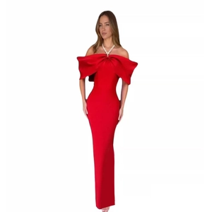 Detail of red off-shoulder satin gown featuring a large oversized bow on the chest