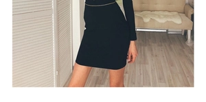 Detailed view of women black bandage mini dress featuring a decorative gold waist chain