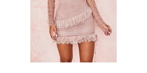 Close-up of pink polka dot lace dress with sheer mesh sleeves and layered ruffles