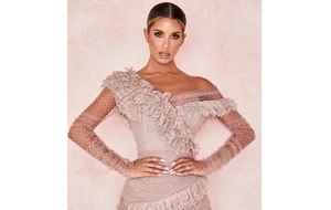 Detail of off-the-shoulder lace mini dress with polka dot mesh sleeves and ruffles