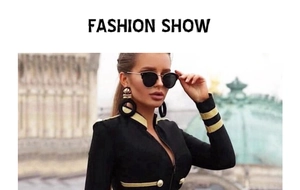 Detail of military style black jacket featuring gold braid trim and metal button accents