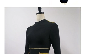 Detail of black long sleeve bandage dress with gold textured buttons and woven trim accents