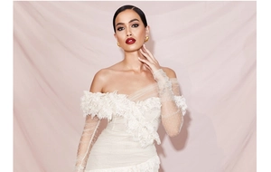 Detailed view of white off-shoulder lace neckline with delicate pleated mesh and polka dots