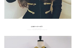 Detail of black long-sleeve top with golden braided ropes and lion-head metal buckles