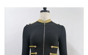 Detail of military jacket with golden braided ropes and embossed metal buttons on front