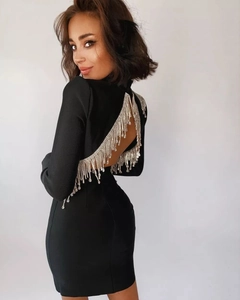Detailed back view of a black bodycon dress featuring crystal fringe on a deep V-back