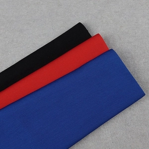 Detailed macro shot of high-quality ribbed knit fabric in black, red, and blue colors