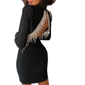 Women's black bodycon dress with long sleeves, backless design, and silver rhinestone fringe