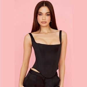 Detail of black slim-fit corset top with square neckline and V-shaped hemline design