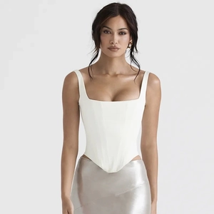 Detailed front view of a white corset top with structured seams and square neckline