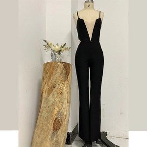 Detail of black backless jumpsuit featuring mesh panels and deep V-neckline on a mannequin