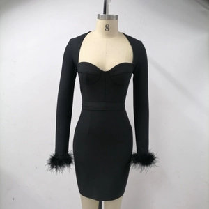 Detail of elegant black bodycon dress featuring faux feather cuffs and sweetheart neckline