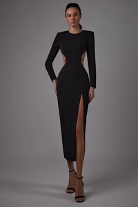 Detailed view of the sleek waist cutout and high side slit on this black bodycon dress