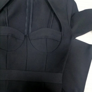 Detail of structured chest cups and cutout design on black long sleeve bandage dress