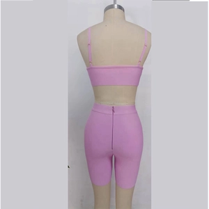 Detail view of the back of a pink-purple two-piece set featuring high-waist shorts with a zipper