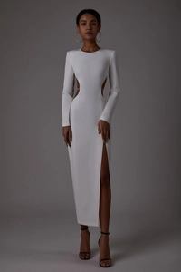 Detail view of white backless dress with waist cut-outs and a high side slit design
