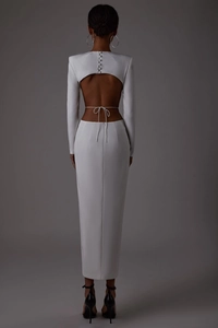 Macro shot of backless cutout detail with buttons on elegant white long sleeve maxi dress
