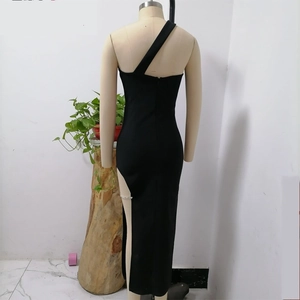 Detail of black one-shoulder dress showing back view and side slit with silver chains