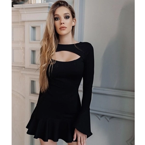 Detail of black long sleeve mini dress featuring chest cutout and ruffled hem design
