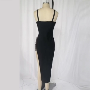 Sexy black bodycon midi dress with spaghetti straps and mesh slit detail on mannequin