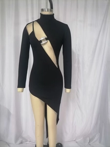 Close-up of asymmetrical cutout black bandage dress with rhinestone buckle and ribbed texture
