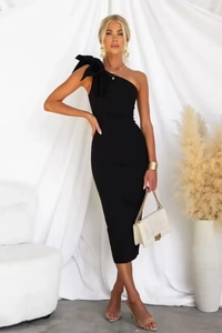 Detail of elegant black one-shoulder bandage dress with a large decorative bow on the shoulder