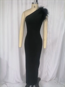 Detail of elegant black one-shoulder dress with ostrich feather trim on the shoulder