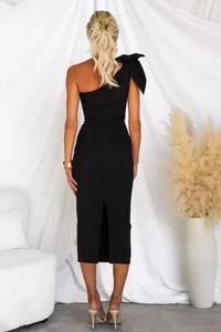 Elegant black one-shoulder midi dress featuring a large bow and rear slit detail