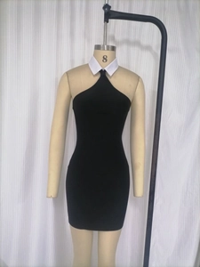 Close-up of contrast white collar and black halter neck design on bodycon bandage dress