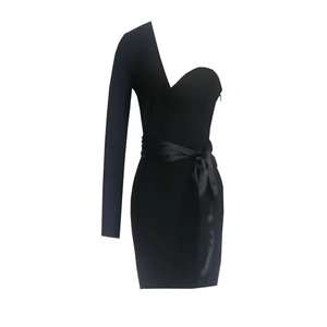 Detail of one-shoulder black bandage dress with long sleeve and satin ribbon waist belt