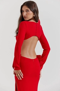 Detail of red long sleeve backless dress featuring a large 3D bow and elegant side slit