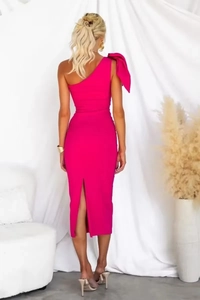 Back view of bodycon midi dress in rose pink featuring a large shoulder bow and back slit