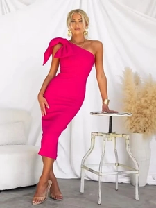 Close-up of a rose red one-shoulder bandage dress featuring a large bow detail