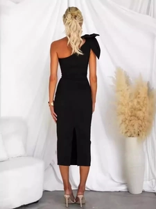 Elegant black one-shoulder midi dress with large bow detail and slim fit back slit