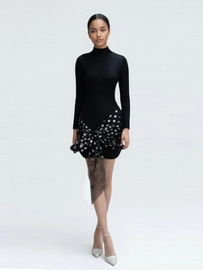 Slim fit black long sleeve mini dress with a large silver polka dot bow and mesh train