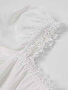 Detail of delicate lace trim and elastic pleated fabric on white A-line dress sleeve