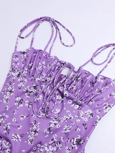 Detail of purple floral dress featuring neckline ruffles and adjustable drawstring ties