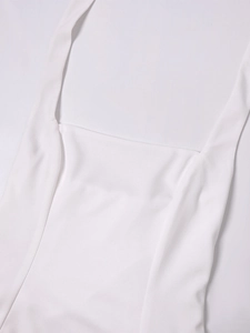Detail of square neckline and thin straps on a white French-style backless mini dress