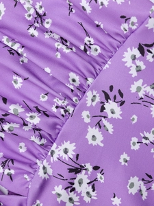 Macro detail of purple floral fabric with white petals and elegant ruching texture