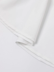 Close-up of the curved hemline with double stitching on a white A-line mini dress