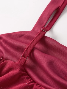 Detail of red mesh dress showing adjustable strap and silver glitter sequins