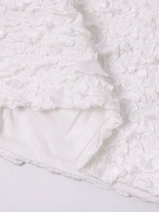 Macro detail of high-quality white popcorn textured fabric with smooth inner lining