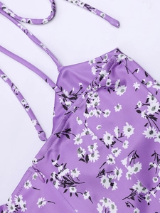 Detailed view of invisible side zipper on purple floral dress with delicate straps