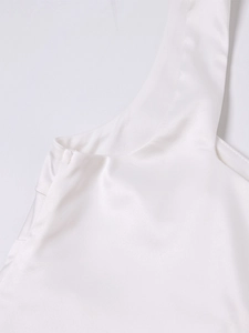 Detailed macro shot of white satin strap stitching and glossy fabric on summer dress