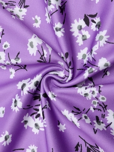 Detailed macro view of purple floral fabric with white daisies and knit texture