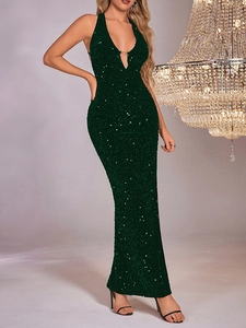 Detail of emerald green sequin dress with deep V-neckline and gold buckle accent